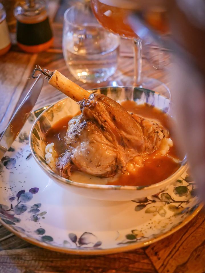 Souris d'agneau braisée en sauce sur purée, vaisselle fleurie rustique
